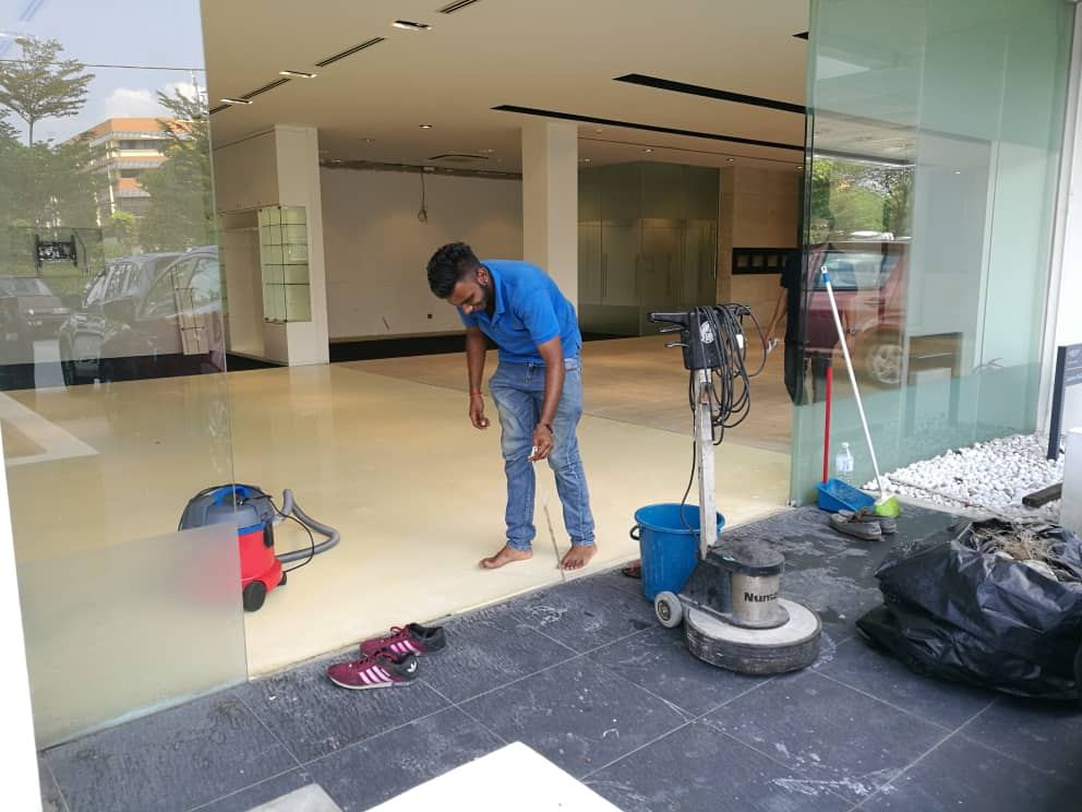 Alam Aman cleaning crew machine-scrubbing a commercial lobby floor in Kuala Lumpur