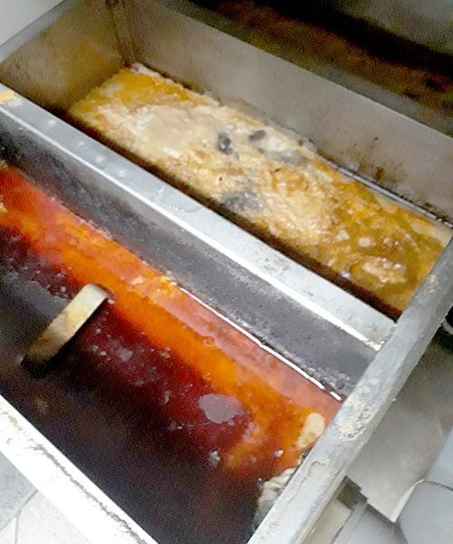 Grease trap full of FOG before cleaning