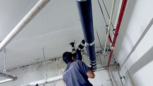 Plumber installing new pipes